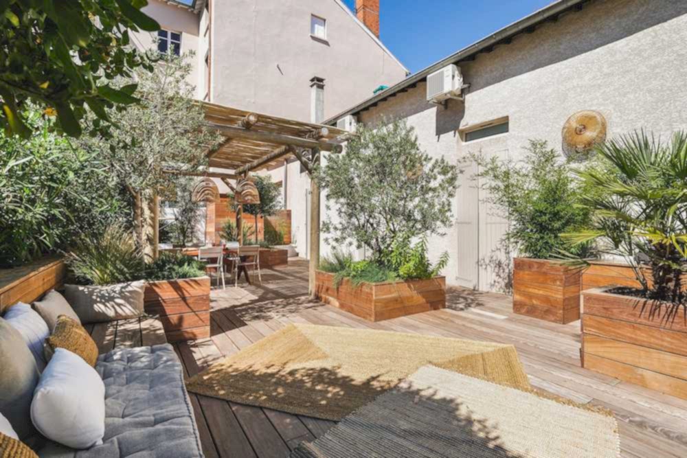 Aménagement d'une terrasse en bois - esprit méditérranéen - espace détente avec végétation